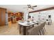 Open concept living with kitchen, living, and dining room with a stone table at 3228 W Mercer Ln, Phoenix, AZ 85029