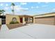 Charming single-story home with desert landscaping, a two-car garage, and a red front door at 3228 W Mercer Ln, Phoenix, AZ 85029