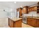 Open kitchen features stainless steel appliances, an island, and granite countertops at 3228 W Mercer Ln, Phoenix, AZ 85029
