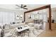 Bright living room featuring a modern sofa, a large rug, and an open floor plan at 3228 W Mercer Ln, Phoenix, AZ 85029