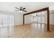 Spacious living room with tile flooring, white walls, and natural light at 3228 W Mercer Ln, Phoenix, AZ 85029