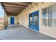 Covered patio with blue doors, beige siding, and concrete flooring at 3228 W Mercer Ln, Phoenix, AZ 85029