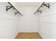 A well-lit walk-in closet featuring built-in shelving at 3228 W Mercer Ln, Phoenix, AZ 85029
