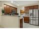 Modern kitchen features stainless steel appliances, wooden cabinetry, and open access to laundry at 3330 S Gilbert Rd # 1020, Chandler, AZ 85286