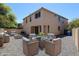 Inviting backyard with comfortable wicker furniture, a glass table, and a gravel landscape perfect for outdoor entertaining at 3330 W Gran Paradiso Dr, Phoenix, AZ 85086