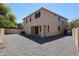 Spacious backyard with gravel, stucco walls, and mature trees, offering a private outdoor space at 3330 W Gran Paradiso Dr, Phoenix, AZ 85086