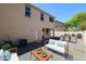 Cozy backyard with stylish outdoor seating, stainless grill, and low-maintenance gravel landscaping at 3330 W Gran Paradiso Dr, Phoenix, AZ 85086