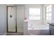 Clean bathroom features a soaking tub, glass shower, and granite countertop at 3330 W Gran Paradiso Dr, Phoenix, AZ 85086