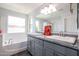 Bright bathroom features a soaking tub, glass shower, granite countertops, and double vanity sinks at 3330 W Gran Paradiso Dr, Phoenix, AZ 85086