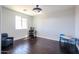 Versatile room with dark wood floors, natural lighting, and space for both work and relaxation at 3330 W Gran Paradiso Dr, Phoenix, AZ 85086