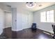 Bright bedroom boasts hardwood floors, a ceiling fan, and large window allowing for ample natural light at 3330 W Gran Paradiso Dr, Phoenix, AZ 85086