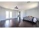 Large bedroom with hardwood floors, modern ceiling light, and an inviting daybed with a breakfast tray at 3330 W Gran Paradiso Dr, Phoenix, AZ 85086
