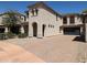 Charming two-story stucco home with a paved driveway and arched entryway provides curb appeal at 3330 W Gran Paradiso Dr, Phoenix, AZ 85086