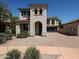 Beautiful two-story home with arched entry, brick driveway, two car garage and desert landscaping at 3330 W Gran Paradiso Dr, Phoenix, AZ 85086