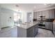 Kitchen island with granite countertops, gray cabinets and stainless steel appliances, lots of natural light at 3330 W Gran Paradiso Dr, Phoenix, AZ 85086