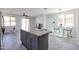 Open kitchen and living area features granite countertops, gray cabinets, and stainless steel appliances at 3330 W Gran Paradiso Dr, Phoenix, AZ 85086