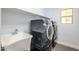 Convenient laundry room features modern appliances, utility sink, and ample shelving at 3330 W Gran Paradiso Dr, Phoenix, AZ 85086