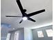 This living room features a modern ceiling fan, bright windows, and neutral colored walls at 3330 W Gran Paradiso Dr, Phoenix, AZ 85086