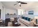 Upstairs living room features plush furniture, ceiling fan, and built-in cabinetry with desk at 3330 W Gran Paradiso Dr, Phoenix, AZ 85086