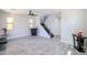 Bright living room with light gray floors, modern furniture, and natural light from large windows at 3330 W Gran Paradiso Dr, Phoenix, AZ 85086
