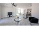 Open-concept living room with gray floors, a modern ceiling fan, and barstool seating at the kitchen island at 3330 W Gran Paradiso Dr, Phoenix, AZ 85086