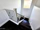 Modern staircase featuring dark wood steps, light gray trim, and black metal balusters at 3330 W Gran Paradiso Dr, Phoenix, AZ 85086