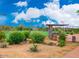 Outdoor community tennis courts with covered seating, desert landscaping, and mountain views at 3330 W Gran Paradiso Dr, Phoenix, AZ 85086