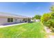 Large, grassy backyard with a covered patio, offering plenty of space for recreation and outdoor activities at 3544 E Fox St, Mesa, AZ 85213