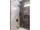 Close-up on updated black shower fixtures and white tile, black tile insert at 3544 E Fox St, Mesa, AZ 85213