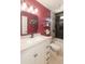 Bright bathroom featuring a white vanity, framed mirror, and shower-over-tub with updated fixtures at 3544 E Fox St, Mesa, AZ 85213