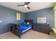 Charming bedroom features carpet flooring, a ceiling fan, and a dresser for storage at 3544 E Fox St, Mesa, AZ 85213