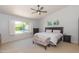Spacious bedroom with a large window offering views of the landscaped backyard at 3544 E Fox St, Mesa, AZ 85213