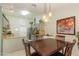 The dining area boasts modern lighting, granite counters, stainless appliances, and an open kitchen view at 3544 E Fox St, Mesa, AZ 85213