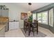 Cozy dining area features a modern chandelier, bay windows, and an adjacent granite-counter kitchen at 3544 E Fox St, Mesa, AZ 85213