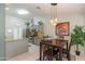 Inviting eat-in kitchen includes pendant lights, granite counters, stainless appliances, and a breakfast nook at 3544 E Fox St, Mesa, AZ 85213