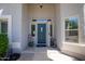 Inviting entryway with a decorative front door, stylish sidelights, and potted plants at 3544 E Fox St, Mesa, AZ 85213