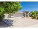 Beautiful home exterior with a well-maintained lawn, mature trees, and a spacious driveway at 3544 E Fox St, Mesa, AZ 85213
