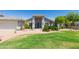 Beautiful single-story home with a lush green lawn and mature desert landscaping at 3544 E Fox St, Mesa, AZ 85213