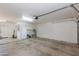 Spacious garage with a utility sink, fridge, and ample room for parking and storage at 3544 E Fox St, Mesa, AZ 85213