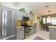 Updated kitchen features stainless appliances, granite counters, and a view of the dining area at 3544 E Fox St, Mesa, AZ 85213
