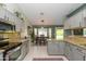 Bright kitchen offers stainless appliances, granite counters, seamlessly connecting to the adjacent dining area at 3544 E Fox St, Mesa, AZ 85213
