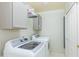 Convenient laundry room includes washer, dryer, and additional storage cabinets for household needs at 3544 E Fox St, Mesa, AZ 85213