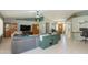 Open-concept living room with tile floors and an inviting sectional sofa at 3544 E Fox St, Mesa, AZ 85213
