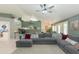 Spacious living room features a plush sectional sofa, neutral tile, and seamless flow into the dining area at 3544 E Fox St, Mesa, AZ 85213