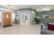 Inviting living room featuring tile floors, a view into the office, and a breakfast bar into the kitchen at 3544 E Fox St, Mesa, AZ 85213