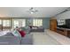 Spacious living room with a ceiling fan, large sectional sofa, and tile floors at 3544 E Fox St, Mesa, AZ 85213