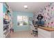 Bright office space features a large window, custom shelving and colorful accent wall at 3544 E Fox St, Mesa, AZ 85213