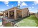 Backyard with covered patio, outdoor seating, artificial turf and a fenced pool at 3797 N 156Th N Dr, Goodyear, AZ 85395