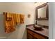 Cozy powder room featuring copper sink, warm-toned accents, and decorative towels at 3797 N 156Th N Dr, Goodyear, AZ 85395