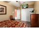 Bedroom featuring wood floors, a mounted television, and closet with sliding doors at 3797 N 156Th N Dr, Goodyear, AZ 85395